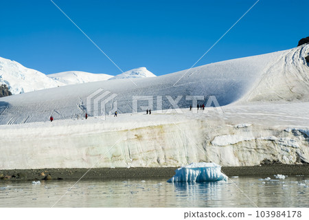 Tourists walking on the ice, Paradise bay, Antartic Peninsula. Tourists walking on the ice, Paradise bay, Antartic Peninsula. 103984178
