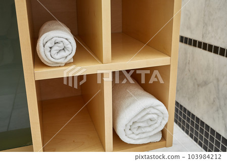 Clean towel in a cabinet 103984212