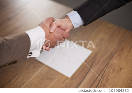 business people handshake over wooden table. businessmen agreement and partnership concept. business people handshake over wooden table. businessmen agreement and partnership concept. 103984283