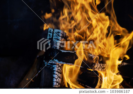In winter months flickering flames of wood fire in traditional rural fireplace bring comfort relaxation. 103986187