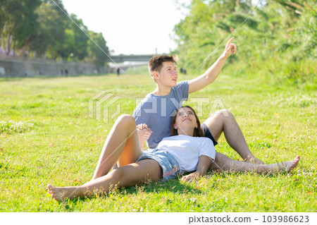 Girl is resting on her boyfriend's lap 103986623