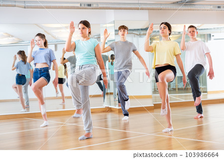 Teenage dancers practicing new dance in studio 103986664