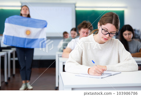 Young girl student diligently studies at school 103986786