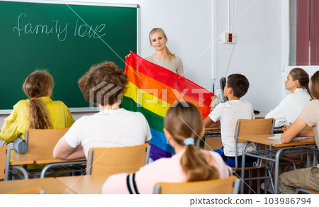 Teacher explaining lgbt theme to children during lesson 103986794