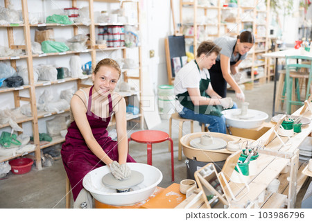 Girl teenager learns how to create pottery in workshop Girl teenager learns how to create pottery in workshop 103986796