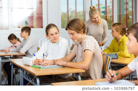 Group of school kids and teacher during lesson Group of school kids and teacher during lesson 103986797