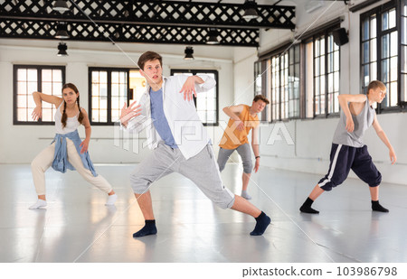 Team of young dancers training moves 103986798