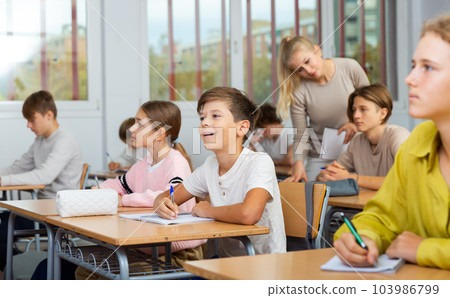 Student is sitting test and answer about task in classroom. Student is sitting test and answer about task in classroom. 103986799
