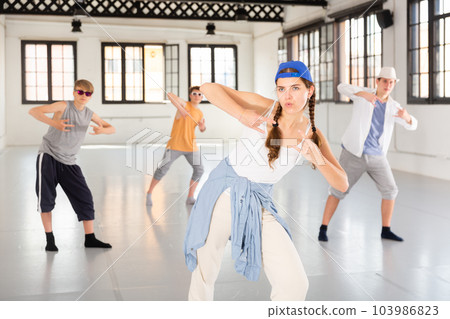 Group teenagers dancing hip-hop indoors 103986823