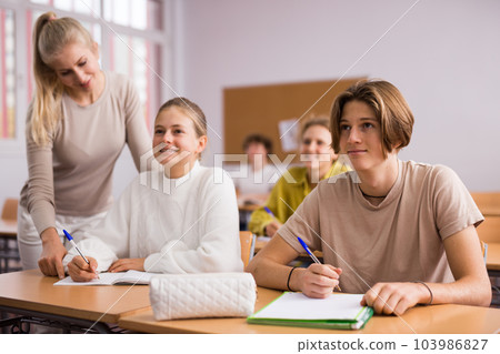 Teenagers doing tasks during lesson in school 103986827