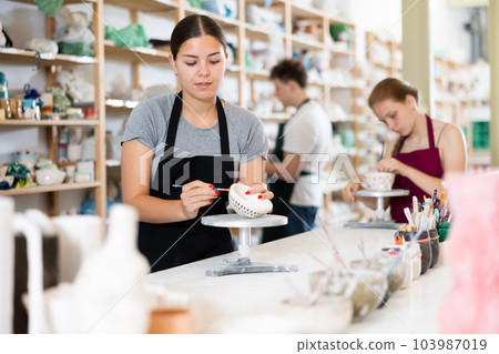 Teenagers are interested in making dishes from clay in pottery workshop 103987019