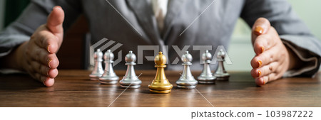 Chess leader and team. Human resources concept career management with clasped hands planning strategy with chess figures. leadership or success teamwork. Inspiration idea of goal 103987222