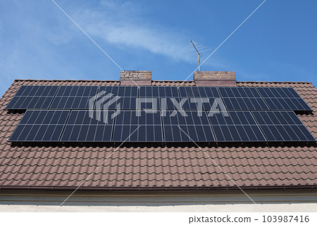 Close-up of a classic family home roof covered with solar panels. 103987416