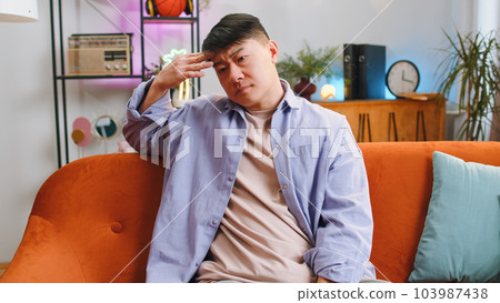 Man guy at home suffers from unfair situation problem, break up, depressed, feeling bad, burnout Man guy at home suffers from unfair situation problem, break up, depressed, feeling bad, burnout 103987438