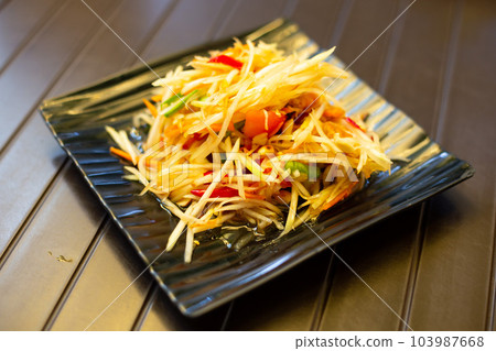 Thai food papaya salad  (Som Tum) on a wooden table 103987668