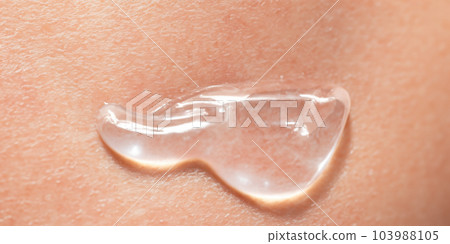 Collagen And Hyaluron Serum Gel On Skin. Splashing of Hyaluron gel. Liquid hyaluronic acid gel on skin. Cosmetic bubbles Gel texture on skin black background. Textured background. skin care product Collagen And Hyaluron Serum Gel On Skin. Splashing of Hyaluron gel. Liquid hyaluronic acid gel on skin. Cosmetic bubbles Gel texture on skin black background. Textured background. skin care product 103988105