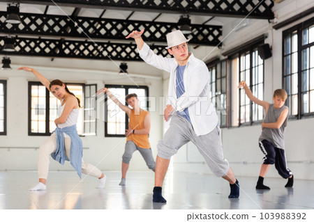 Group teenagers dancing hip-hop indoors Group teenagers dancing hip-hop indoors 103988392
