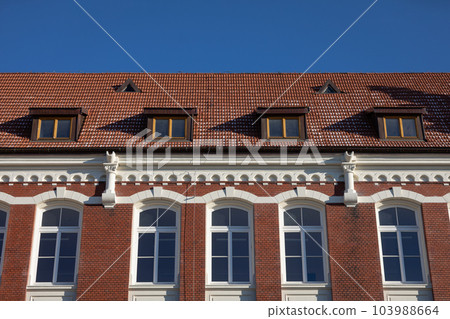 The curtain wall of a historic building maintained in the Neo-Gothic style. 103988664