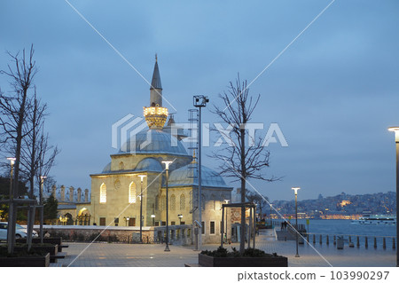 a beautiful mosque in a dark cloudy weather at night  103990297