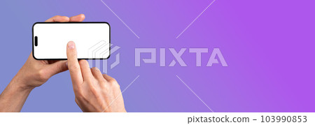 Lodz, Poland May 14 2023 hand holding iphone 14 pro max phone mockup, clicking on horizontal display mock-up. Banner background with copy space for text 103990853