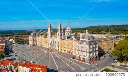 Aerial view of the Palace of Mafra. Unesco world heritage in Portugal. Aerial top view of the Royal Convent and Palace of Mafra, baroque and neoclassical palace. Drone view of a historic castle. Aerial view of the Palace of Mafra. Unesco world heritage in Portugal. Aerial top view of the Royal Convent and Palace of Mafra, baroque and neoclassical palace. Drone view of a historic castle. 103990973