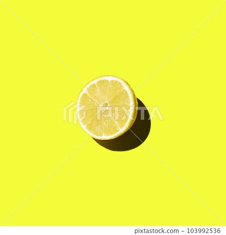 Fresh cut lemon lies on a yellow background isolate top view 103992536