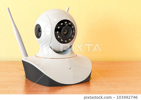 IP camera on the wooden table. 3D rendering IP camera on the wooden table. 3D rendering 103992746