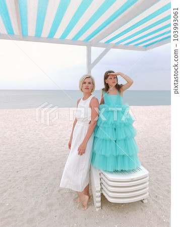 Family relationship, mother with daughter are walking on the beach. Vacation concept, free space 103993061