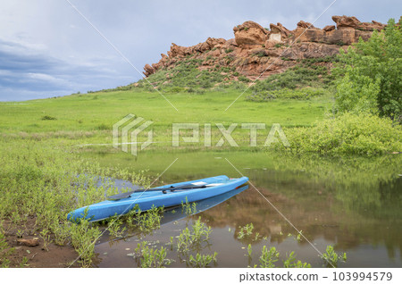 touring stand up paddleboard on a lake at Colorado foothills - Horsetooth Reservoir in late spring scenery touring stand up paddleboard on a lake at Colorado foothills - Horsetooth Reservoir in late spring scenery 103994579