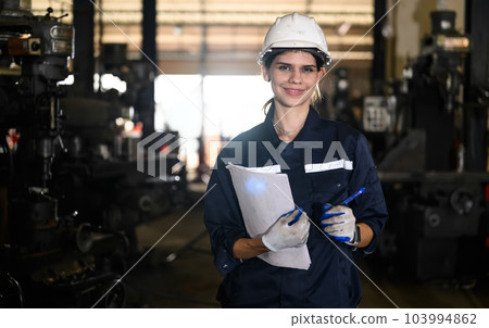 Portrait of happy mechanical engineer smiling with arm crossed Portrait of happy mechanical engineer smiling with arm crossed 103994862