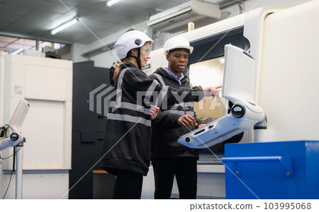 Technician engineer team checking and repairing part of automatic machine 103995068