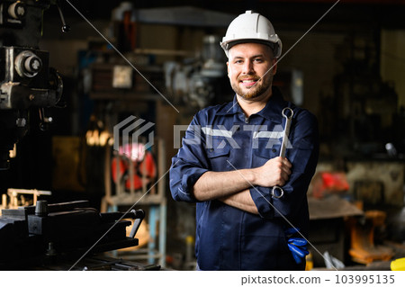 Portrait of happy mechanical engineer smiling with arm crossed 103995135