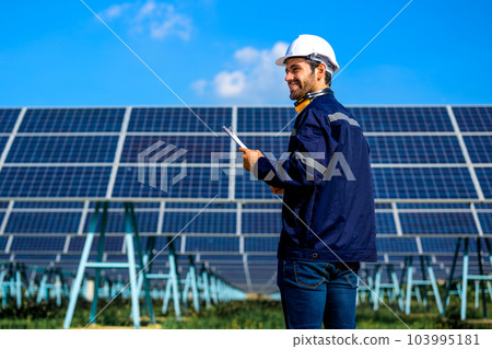 Engineer worker portrait with solar panel at solar farm Engineer worker portrait with solar panel at solar farm 103995181