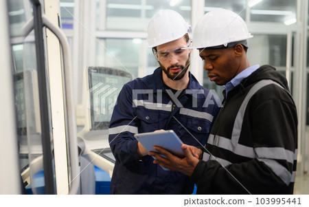 Technician engineer team checking and repairing part of automatic machine 103995441