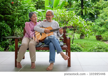 Happy senior grandparents playing guitar and singing songs having fun Happy senior grandparents playing guitar and singing songs having fun 103995446