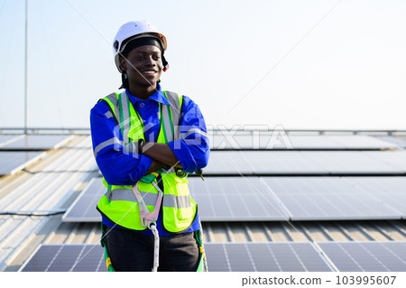 Smiling portrait of happy engineer technician working on rooftop 103995607