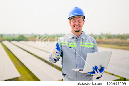 Maintenance technician working on ecological solar cell farm 103995609