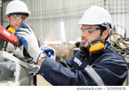Engineer technician controlling robotic arms on computer laptop 103995636