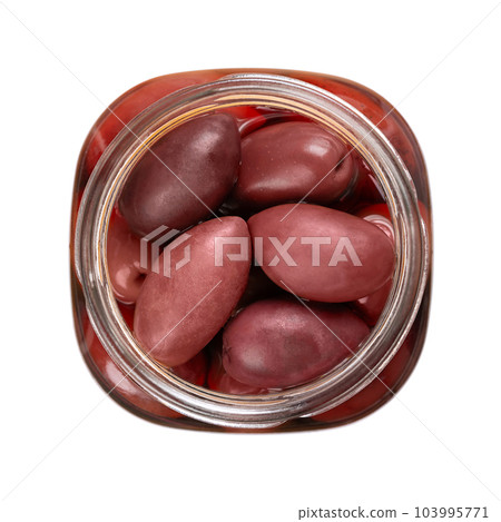 Kalamata olives in an open jar, from above. Whole, large and dark purple table olives from the Kalamata region in Greece. Hand-picked when ripe, preserved in brine, filled in a glass with screw cap. 103995771