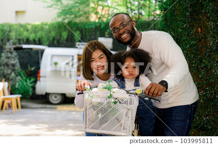 Portrait of happy family father mother and daughter spending vacation 103995811