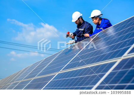 Solar panel station, Engineer installing solar panel at solar energy farm field Solar panel station, Engineer installing solar panel at solar energy farm field 103995888