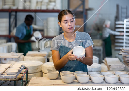 Young woman potter with new crafted ceramic bowls 103996831