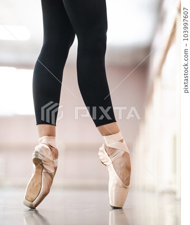 Close-up but ballerinas in pointe shoes in a dance class.  103997607