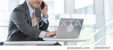 中年商人(老闆、總裁、領導)在辦公室用智能手機交談 中年商人(老闆、總裁、領導)在辦公室用智能手機交談 104000447