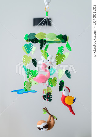 Baby crib mobile hanging in the nursery room, colorful forest-themed cot mobile. Baby crib mobile hanging in the nursery room, colorful forest-themed cot mobile. 104001202