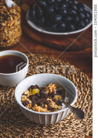 Granola with Dried Fruits and Chocolate in a Bowl Granola with Dried Fruits and Chocolate in a Bowl 104001988