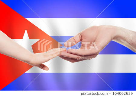 Cuban baby and parent hands on the background of flag of Cuba Help, aid, support, charity concept 104002639
