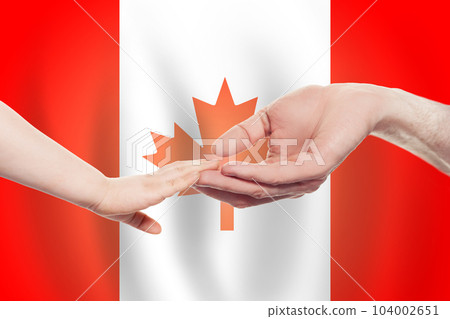Canadian baby and parent hands on the background of flag of Canada Help, aid, support 104002651