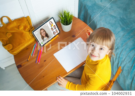 Young girl studying online at home. Arts class 104002931