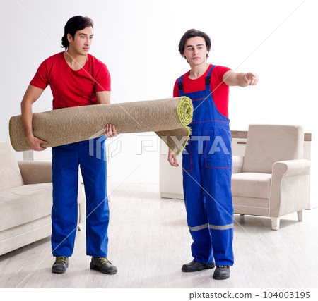 Two young contractor employees moving personal belongings Two young contractor employees moving personal belongings 104003195